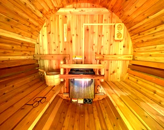 Cedar barrel sauna interior with bench and heater